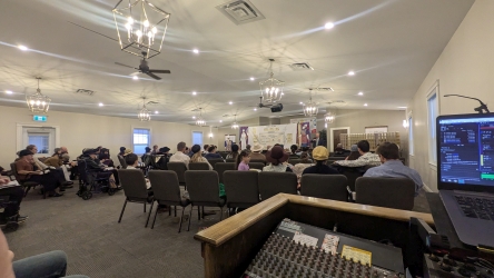 Scott MacLeod preaching on the Tabernacle while the congregation listens