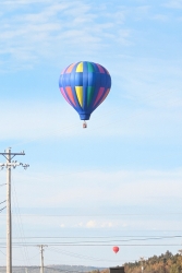 Hot air balloon lifting over the valley