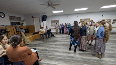 Singing together around the front of the hall