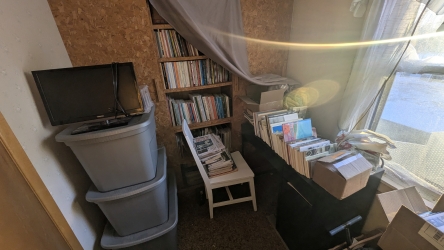 Office mid-cleanup, desk partially uncovered