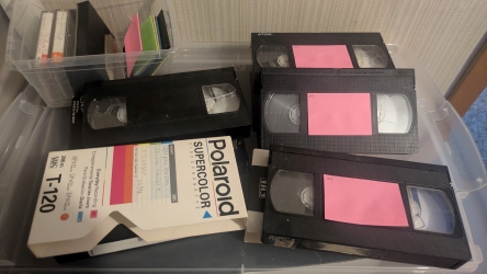 Stack of VHS tapes waiting to be digitized